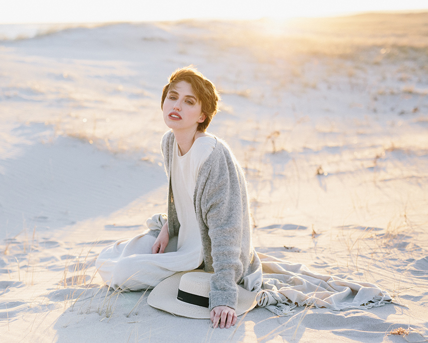 women sitting on sand