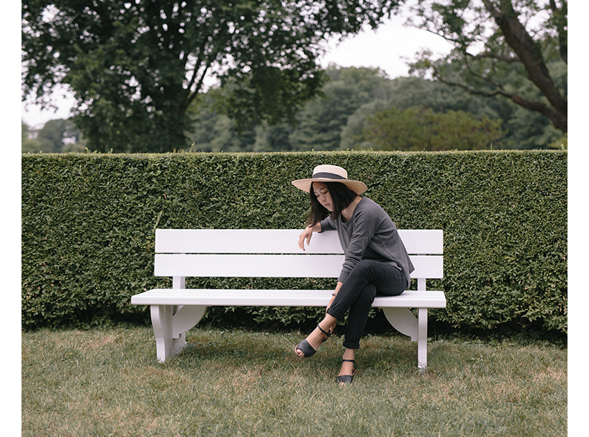 women sitting on bench in garden
